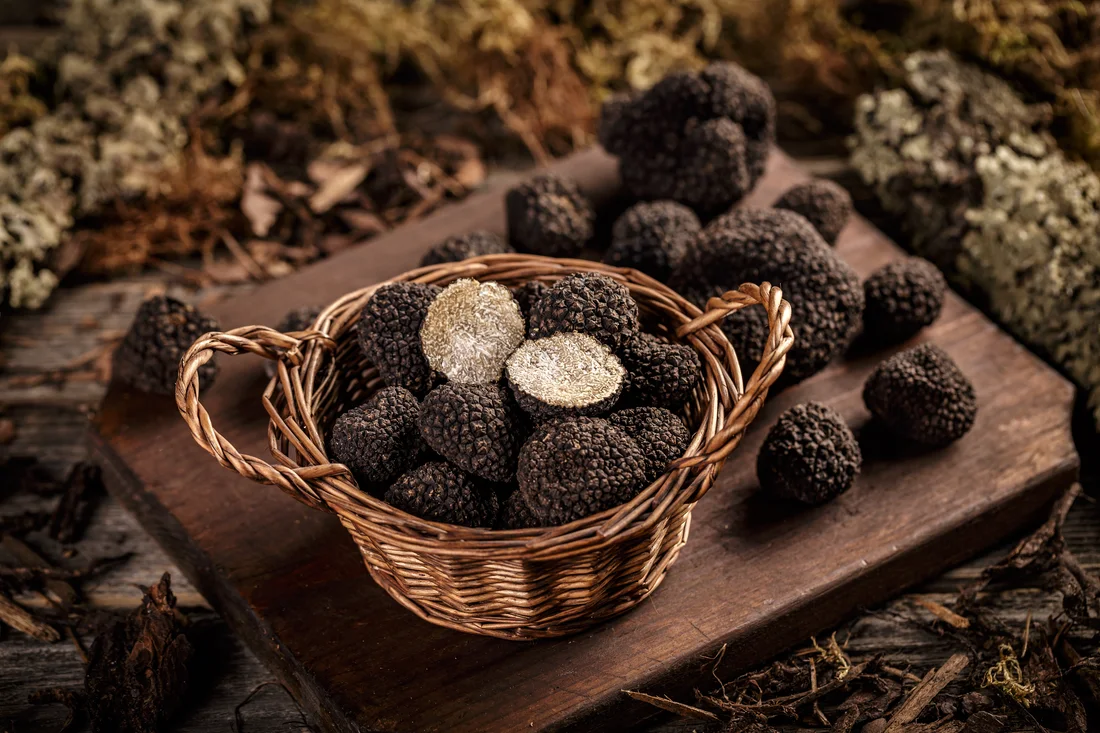Whole and sliced truffles in a wicker basket, from the supplied truffle brochure